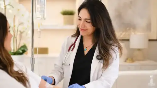 Physician attending an IV treatment in a clinic
